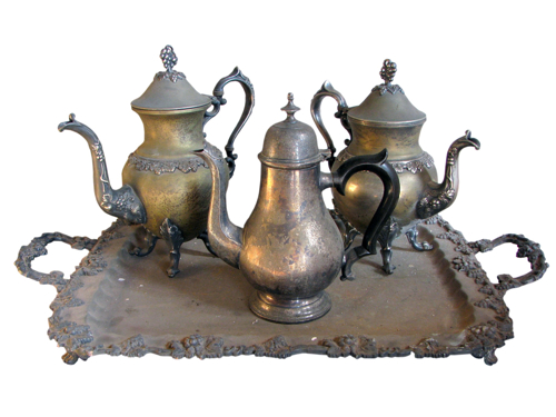 The history of tea - some old silver teapots on a tray